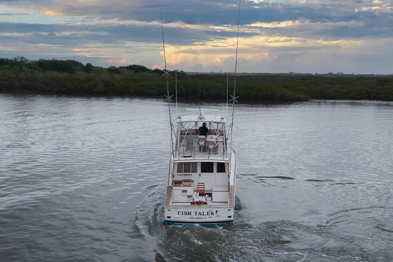 Slide: The Image of 1982 Post 46 Convertible boat cruising on a calm river at sunset. - 12