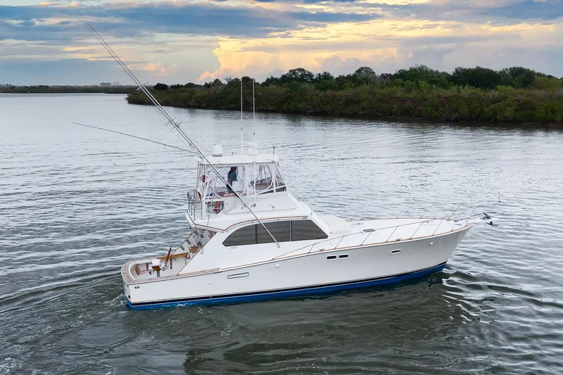 Slide: The Image of 1982 Post 46 Convertible yacht cruising on calm waters at sunset. - 14