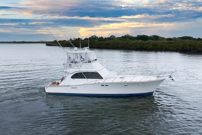 Slide: The Image of 1982 Post 46 Convertible yacht cruising on calm waters at sunset. - 15