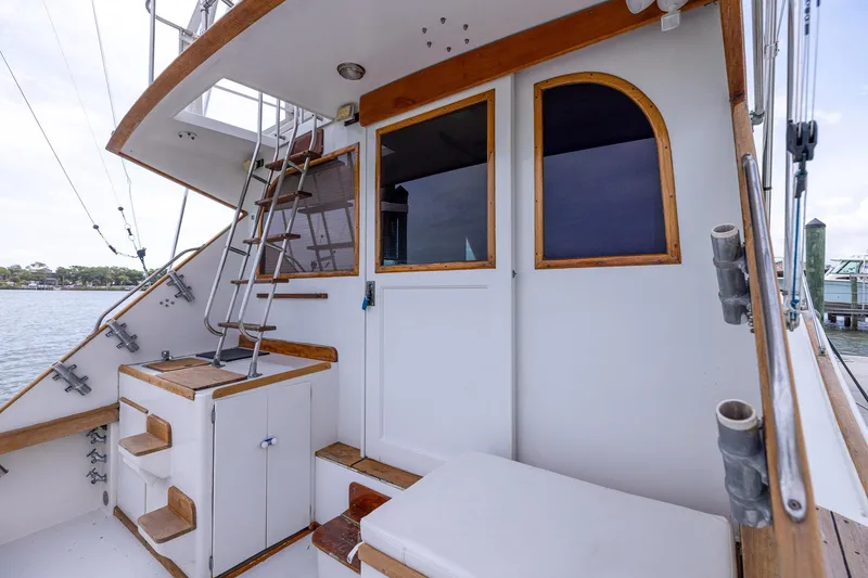 Slide: The Image of 1982 Post 46 Convertible boat deck with ladder and wooden accents. - 29