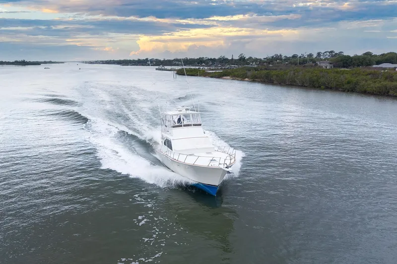 Slide: The Image of 1982 Post 46 Convertible yacht cruising on a scenic waterway at sunset. - 3