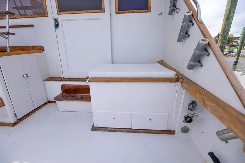 Slide: The Image of 1982 Post 46 Convertible boat interior with wooden accents and storage compartments. - 32