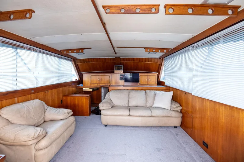 Slide: The Image of Interior of 1982 Post 46 Convertible yacht with beige sofas and wooden cabinetry. - 33