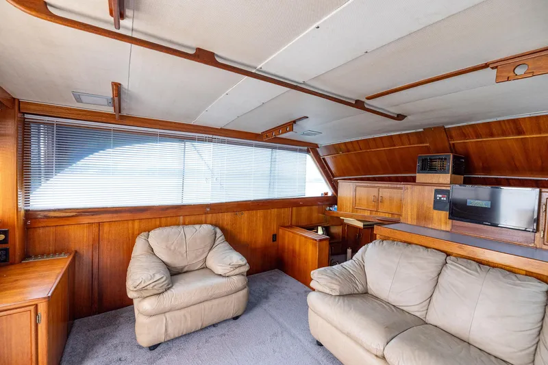 Slide: The Image of Interior of 1982 Post 46 Convertible yacht with wood paneling and beige seating. - 34