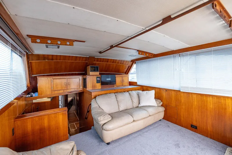 Slide: The Image of Interior of 1982 Post 46 Convertible yacht with wood paneling and beige sofa. - 35