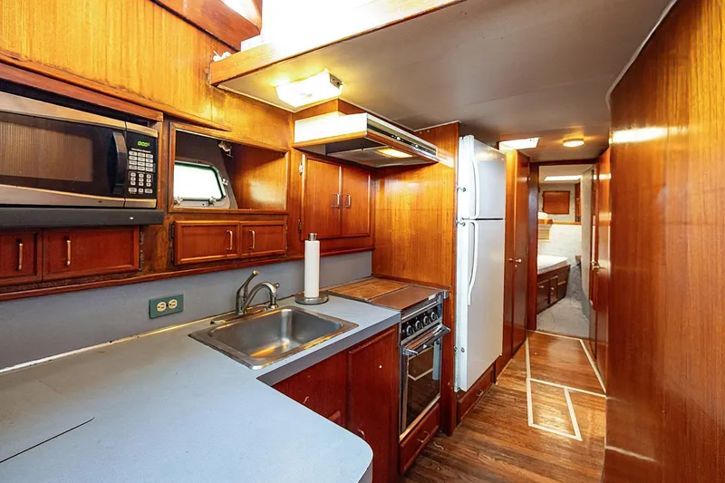 Slide: The Image of 1982 Post 46 Convertible yacht kitchen with wood cabinetry, appliances, and sink. - 38