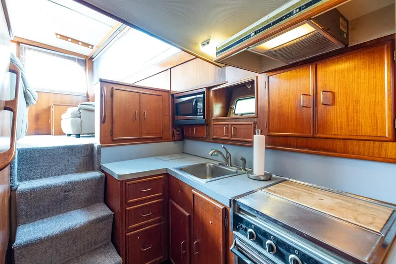 Slide: The Image of Interior of 1982 Post 46 Convertible yacht kitchen with wooden cabinets and appliances. - 39