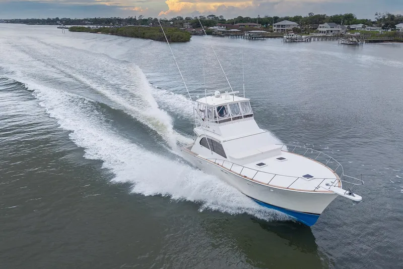 Slide: The Image of 1982 Post 46 Convertible yacht cruising on a serene waterway at sunset. - 4