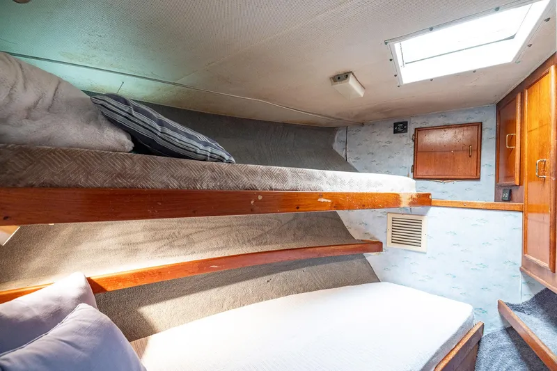 Slide: The Image of Cozy cabin interior of 1982 Post 46 Convertible yacht with bunk beds and wooden accents. - 44