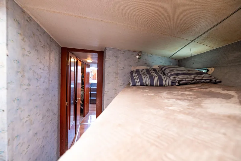 Slide: The Image of Interior of 1982 Post 46 Convertible yacht with cozy bunk bed and striped pillows. - 45
