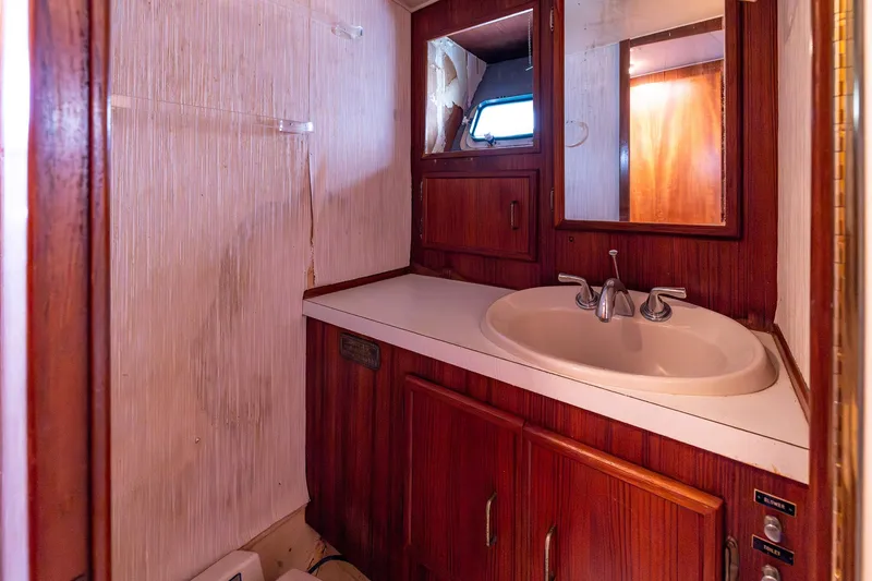 Slide: The Image of 1982 Post 46 Convertible yacht bathroom with wooden cabinetry and sink. - 46