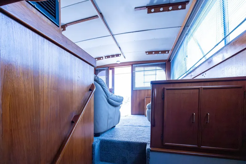 Slide: The Image of Interior of 1982 Post 46 Convertible yacht with wooden paneling and large windows. - 47