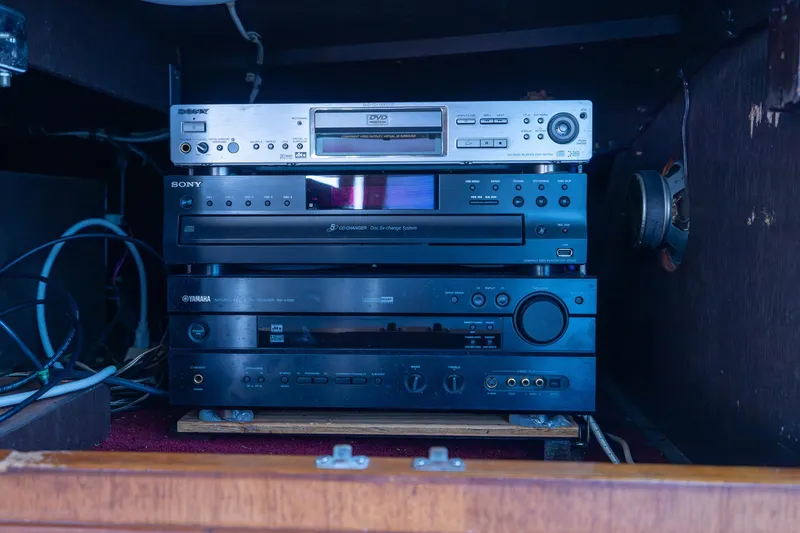 Slide: The Image of Vintage audio equipment setup in a wooden cabinet, featuring Sony and Yamaha components. - 49