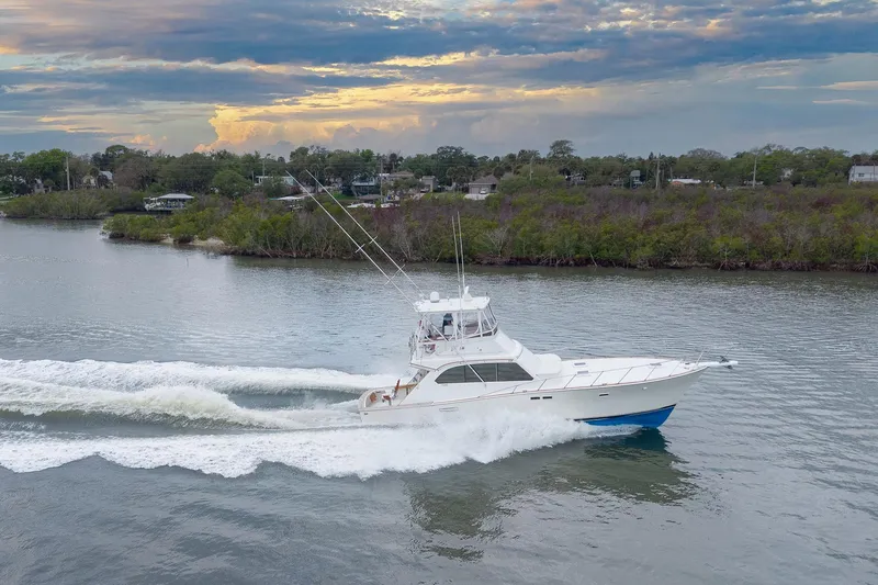 Slide: The Image of 1982 Post 46 Convertible yacht cruising on a scenic river at sunset. - 5