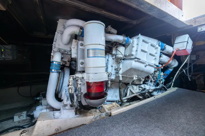 Slide: The Image of Engine room of a 1982 Post 46 Convertible boat, showcasing mechanical components. - 52