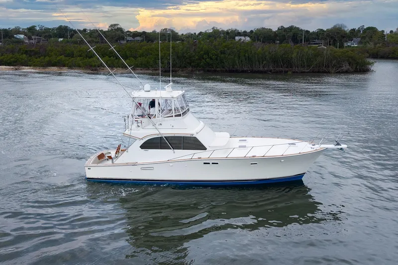 Slide: The Image of 1982 Post 46 Convertible yacht cruising on calm waters at sunset. - 6