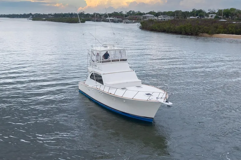 Slide: The Image of 1982 Post 46 Convertible yacht cruising on a serene waterway at sunset. - 7