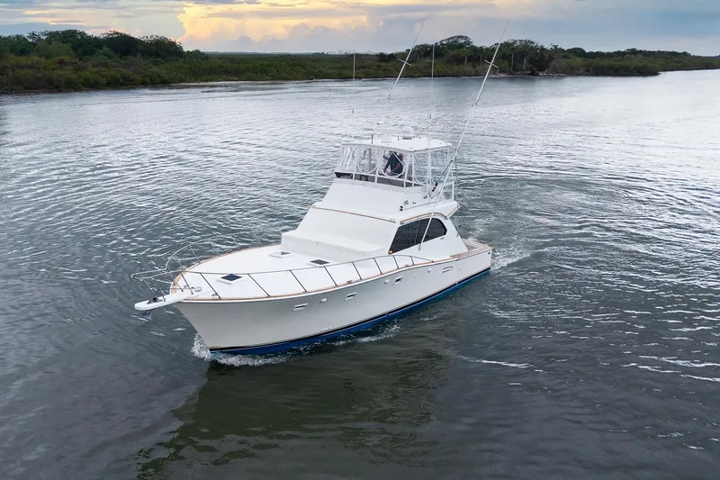 Slide: The Image of 1982 Post 46 Convertible yacht cruising on a calm river at sunset. - 9