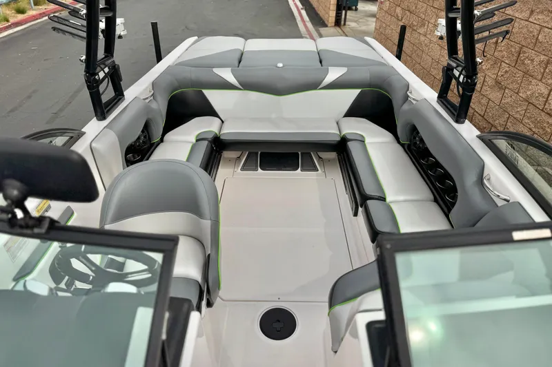 Slide: The Image of 2016 Moomba Craz boat interior with gray seating and green accents. - 14