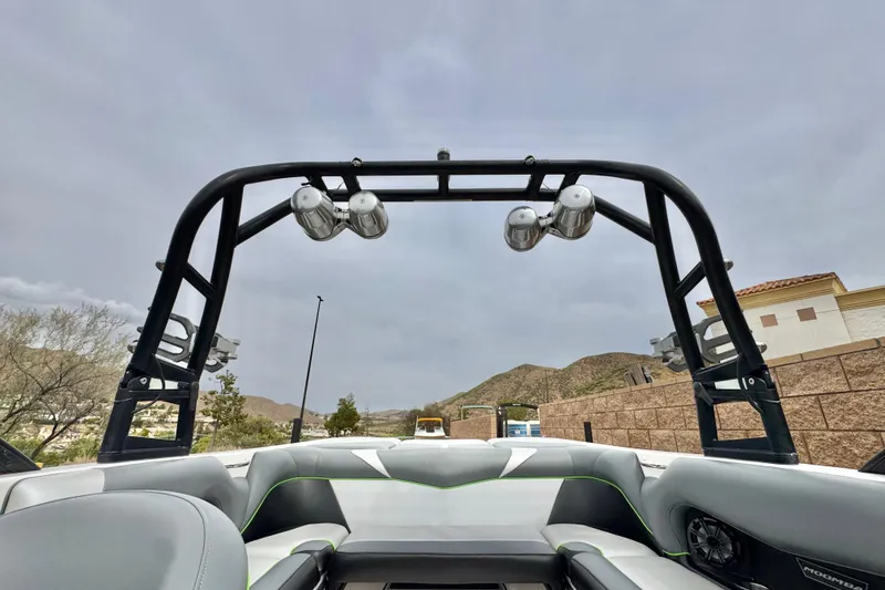 Slide: The Image of 2016 Moomba Craz boat interior with wakeboard tower and speakers, set against a mountainous backdrop. - 15