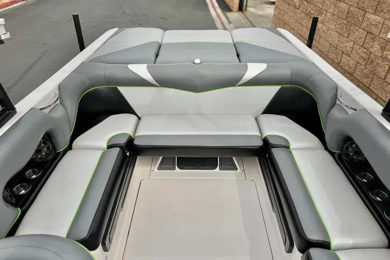 Slide: The Image of 2016 Moomba Craz boat interior with gray and white seating, accented by green piping. - 18