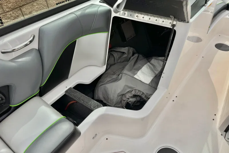 Slide: The Image of 2016 Moomba Craz boat interior with storage compartment and gray upholstery. - 23