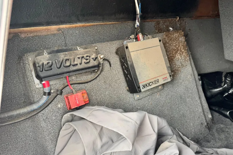 Slide: The Image of 2016 Moomba Craz interior showing 12-volt power setup and Kicker amplifier. - 24