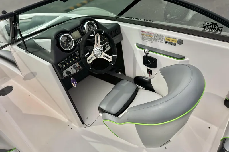 Slide: The Image of 2016 Moomba Craz boat interior with steering wheel and dashboard controls. - 26