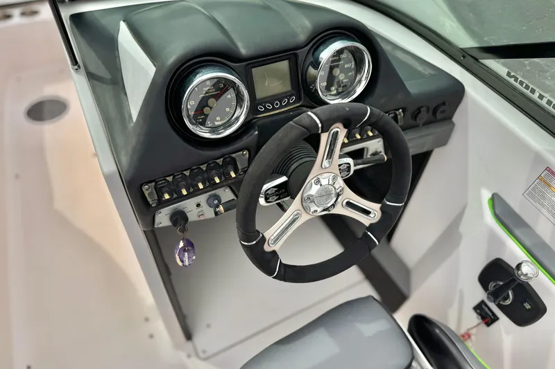 Slide: The Image of 2016 Moomba Craz boat dashboard with steering wheel and instrument panel. - 28