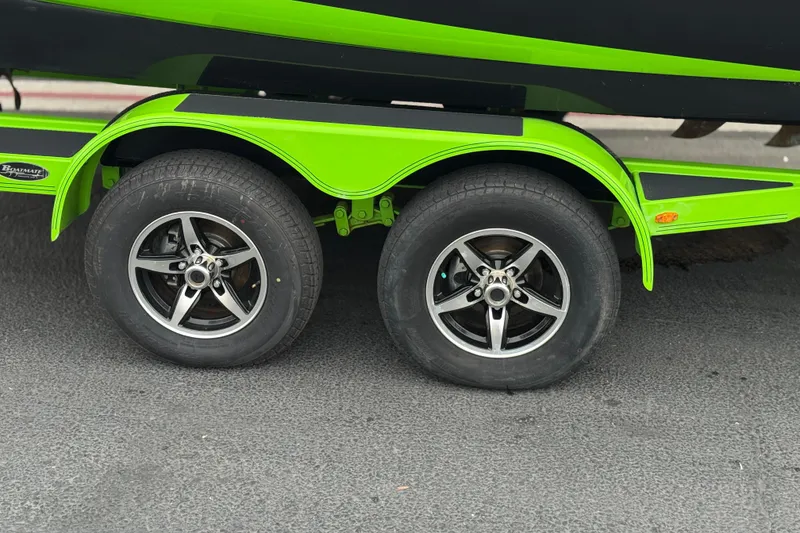 Slide: The Image of Trailer wheels of a 2016 Moomba Craz boat, featuring vibrant green accents. - 29