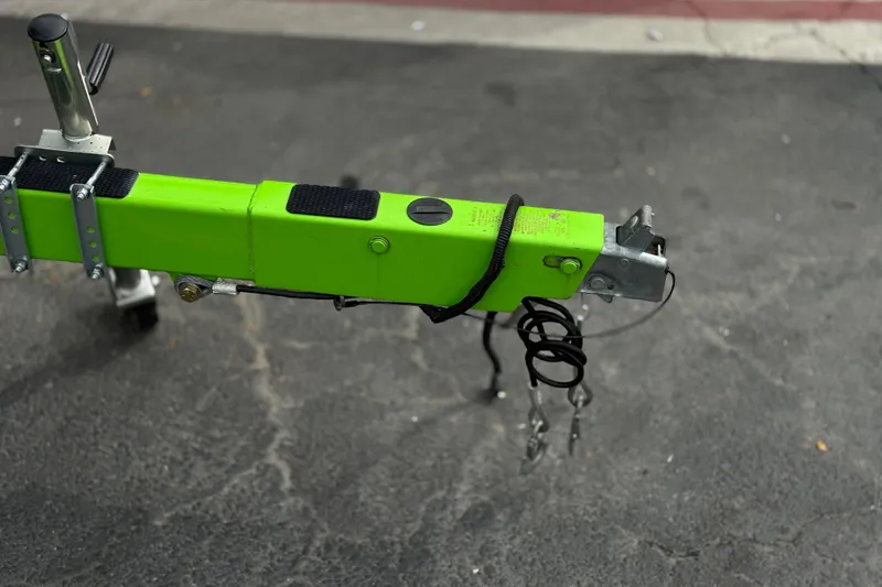 Slide: The Image of Trailer hitch of a 2016 Moomba Craz boat, featuring a bright green finish. - 30