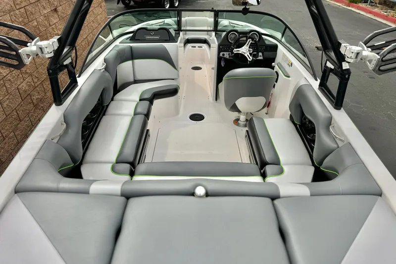Slide: The Image of 2016 Moomba Craz boat interior with gray seating and green accents. - 8