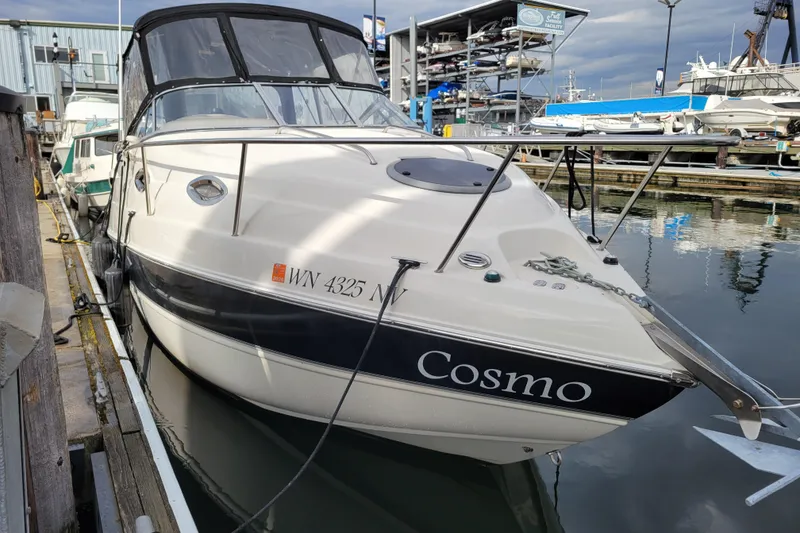 The Image of 2007 Stingray 250 CS boat named "Cosmo" docked at a marina. - 0