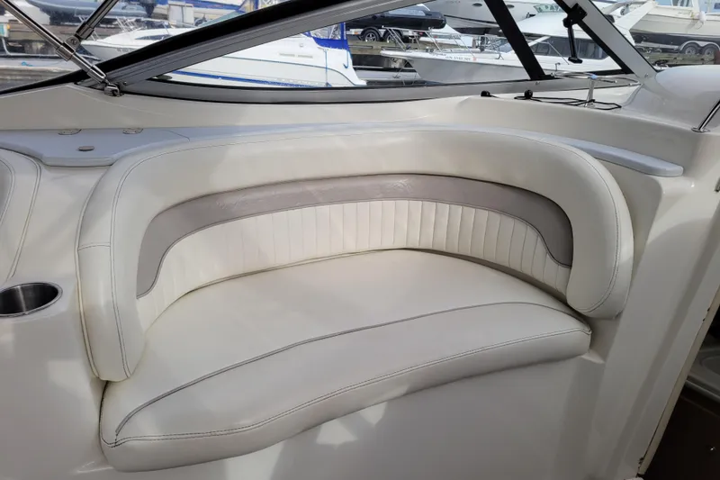 Slide: The Image of 2007 Stingray 250 CS boat interior with white cushioned seating. - 13