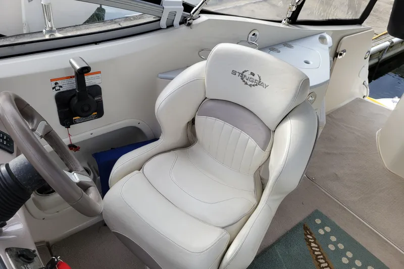 Slide: The Image of 2007 Stingray 250 CS boat interior with steering wheel and captain's seat. - 14