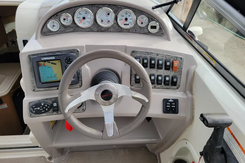 Slide: The Image of 2007 Stingray 250 CS boat dashboard with steering wheel, gauges, and navigation system. - 15