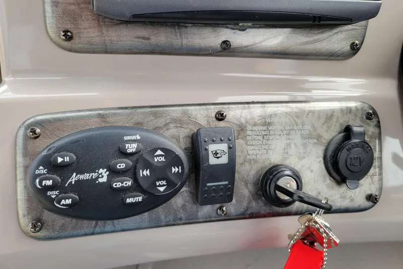 Slide: The Image of Control panel of a 2007 Stingray 250 CS boat with stereo and ignition. - 19