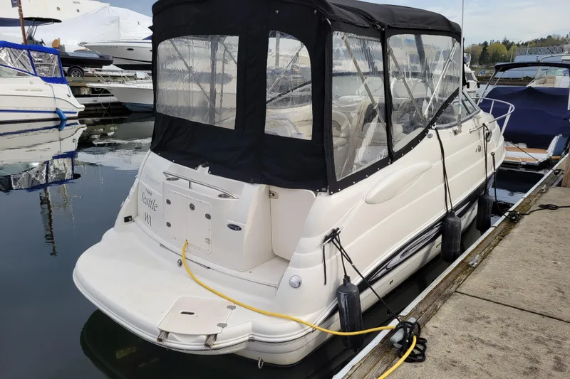 Slide: The Image of 2007 Stingray 250 CS boat docked at marina with protective cover. - 2