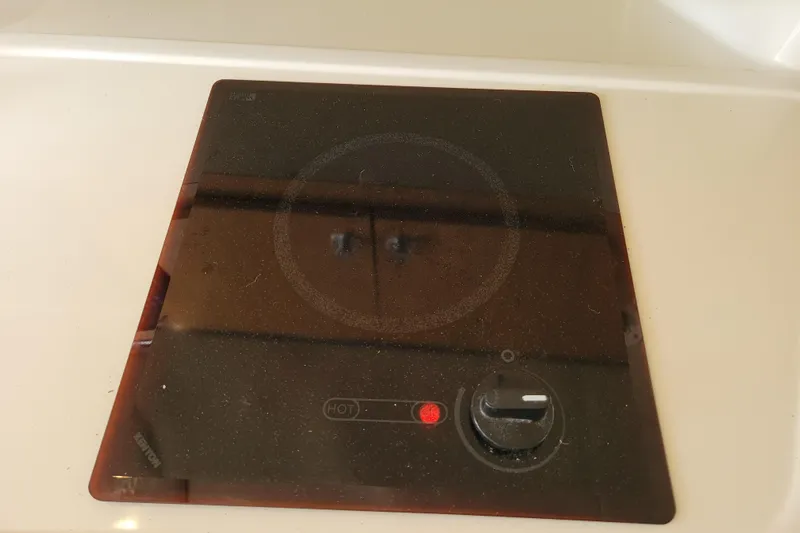 Slide: The Image of Black glass cooktop with control knob, installed on a 2007 Stingray 250 CS boat. - 25