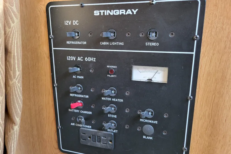 Slide: The Image of Control panel of a 2007 Stingray 250 CS boat, featuring various electrical switches. - 29