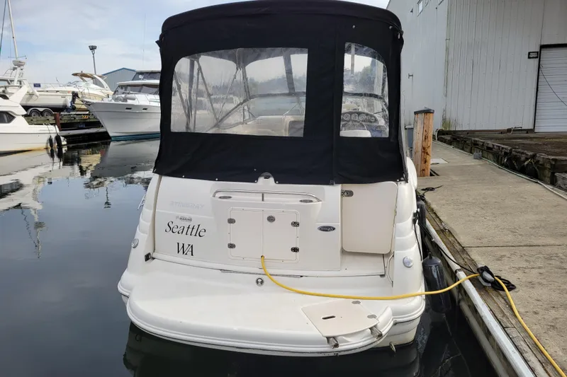 Slide: The Image of 2007 Stingray 250 CS boat docked in Seattle marina, rear view with black canopy. - 3
