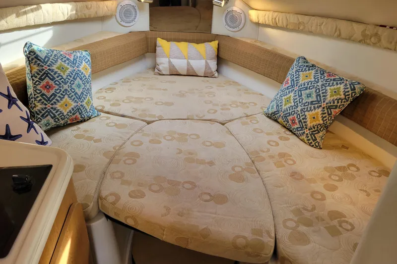 Slide: The Image of Cozy interior of 2007 Stingray 250 CS boat with patterned cushions and pillows. - 33