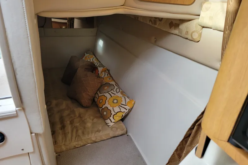 Slide: The Image of Cozy cabin interior of 2007 Stingray 250 CS boat with decorative pillows. - 35