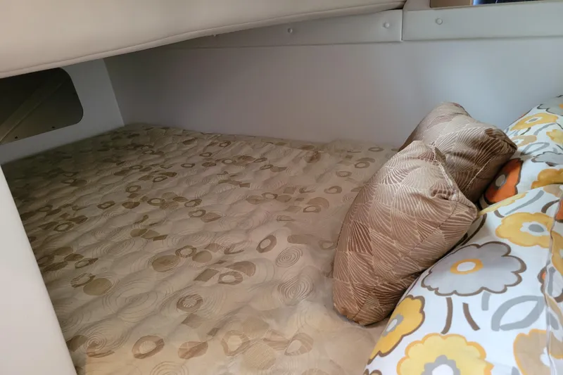 Slide: The Image of Cozy cabin interior of 2007 Stingray 250 CS with patterned bedding and pillows. - 36