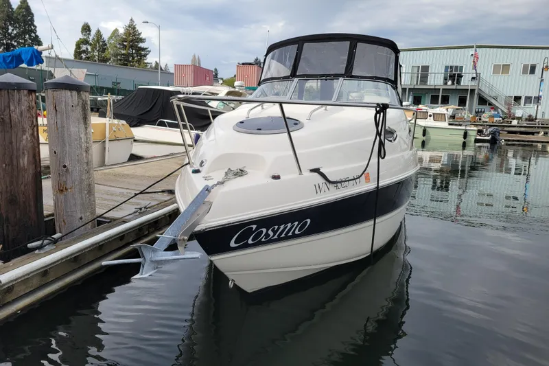 Slide: The Image of 2007 Stingray 250 CS boat named "Cosmo" docked at a marina. - 4