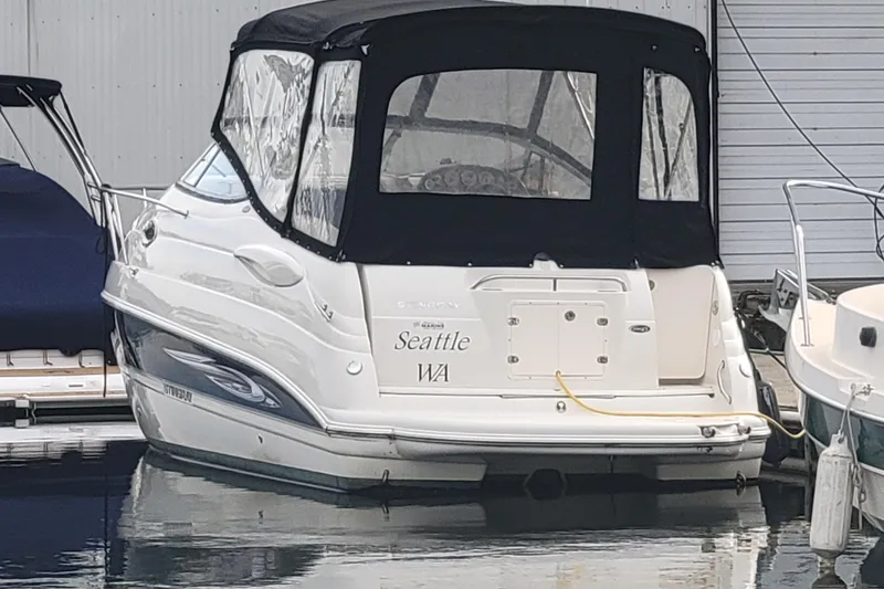 Slide: The Image of 2007 Stingray 250 CS boat docked in Seattle marina with black canopy. - 7