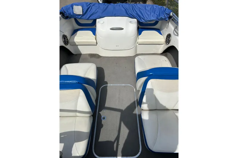 Slide: The Image of Interior view of a 2007 Bayliner 175 boat with blue and white seating. - 10