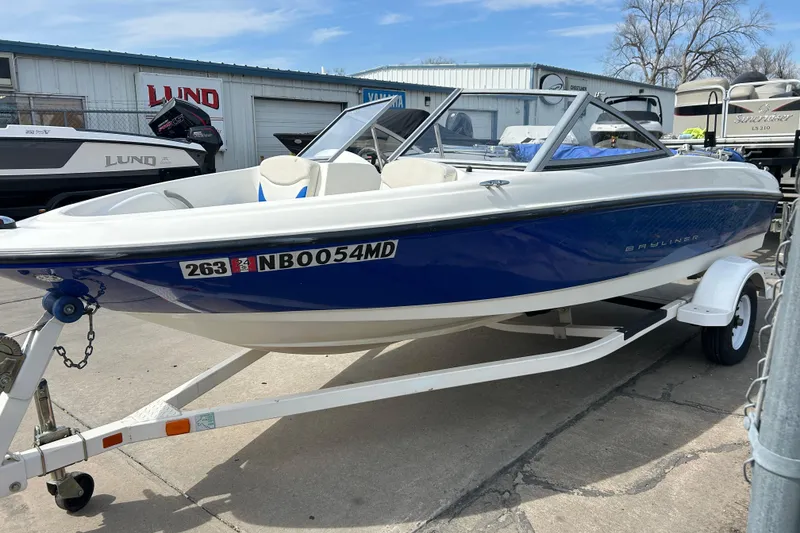 Slide: The Image of 2007 Bayliner 175 boat on trailer, parked outdoors near dealership. - 2