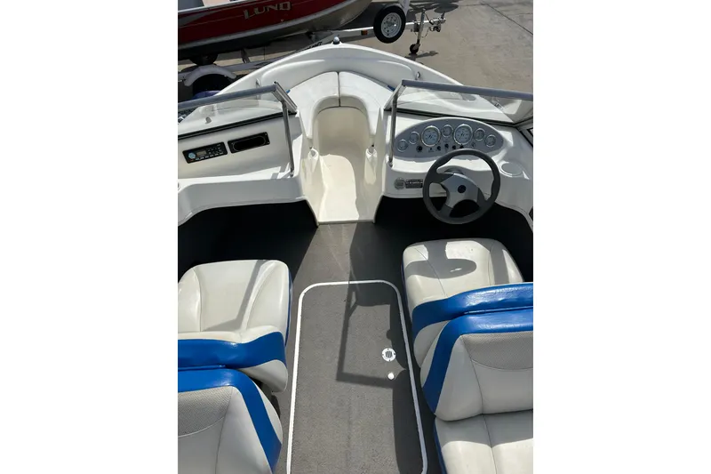 Slide: The Image of 2007 Bayliner 175 boat interior with steering wheel and seating. - 7