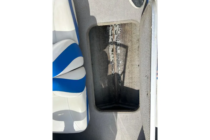 Slide: The Image of Interior view of a 2007 Bayliner 175 boat showing seating and storage compartment. - 9